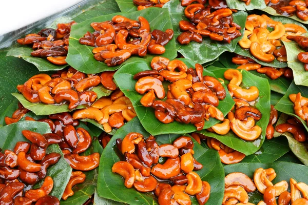 Cashew nut with honey on leaves. — Stock Photo, Image