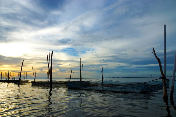 Silhouettes fish farming in the middle of lagoon — Stock Photo, Image