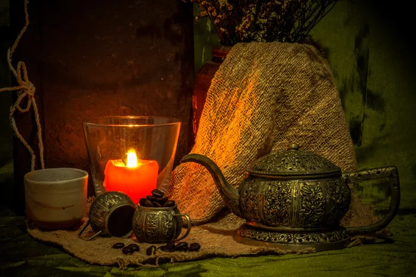 Still life with candle and ancient silver teapot. — Stock Photo, Image