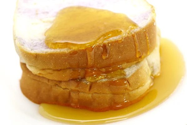 Pan y miel en plato, aislados en blanco — Foto de Stock