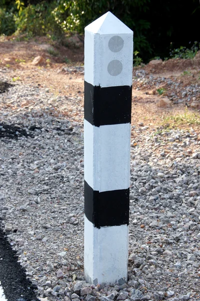 Stone pillars prevent accidents on the road curved. — Stock Photo, Image