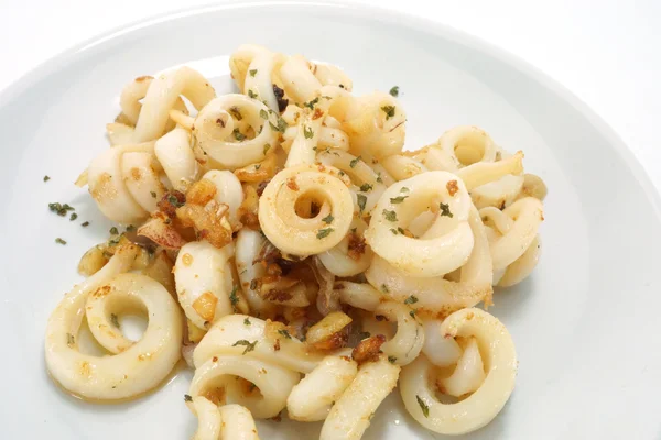 Fried squid with garlic and rosemary mixture. — Stock Photo, Image