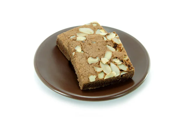 Chocolate cake with almonds on white isolated background — Stock Photo, Image
