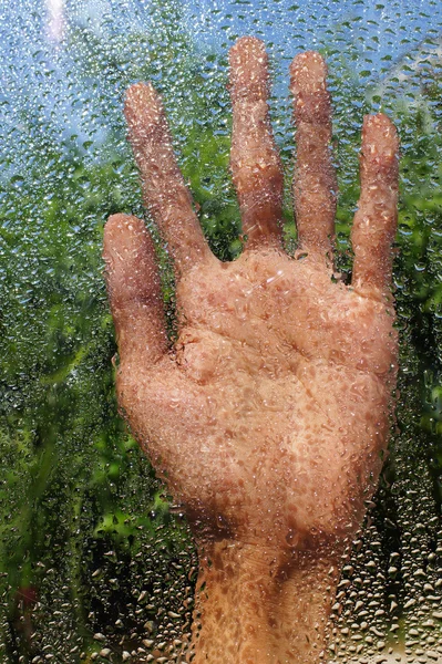 Mão e gotas de água em vidro . — Fotografia de Stock