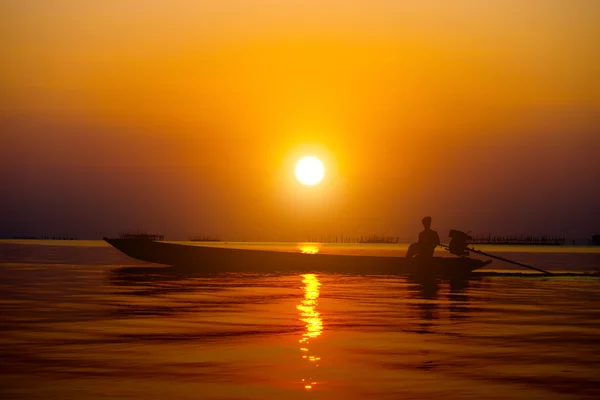 Silhouette pescatore e tramonto sul lago . — Foto Stock