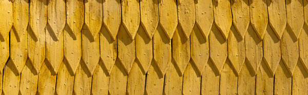 Yellow wooden roof at daytime outdoors, banner 