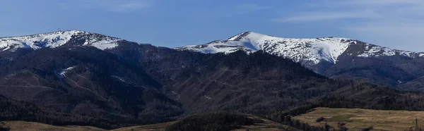 Blue sky above mountains with snow, banner 