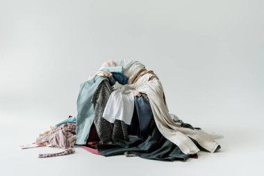 pile of various garments on grey background