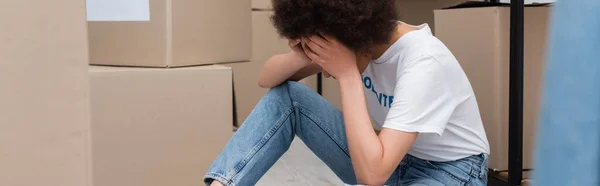 Tired African American Volunteer Obscuring Face Hands Carton Boxes Donation — Stockfoto