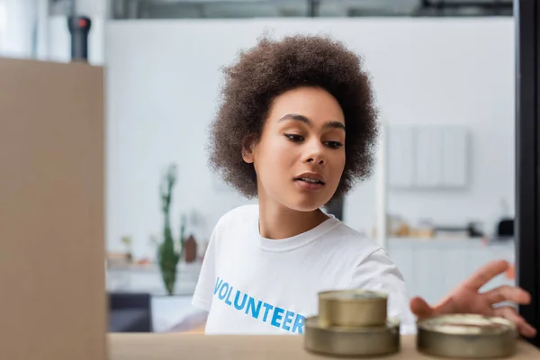 Young African American Volunteer Blurred Tins Donation Warehouse — Stock Photo, Image