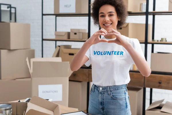 Cheerful African American Woman Showing Heart Sign While Working Charity — Foto de Stock
