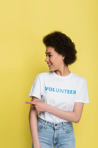 Joyful African American Volunteer Pointing Away Finger Isolated Yellow — Stock Photo, Image