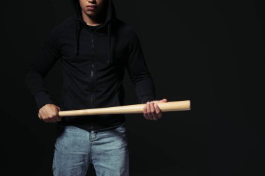 Cropped view of african american hooligan holding baseball bat isolated on black  clipart