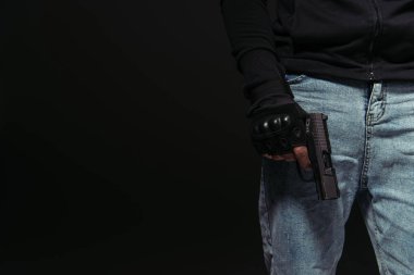 Cropped view of african american hooligan holding handgun isolated on black  clipart