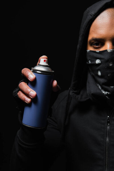 Cropped view of african american bandit with mask on face holding spray paint isolated on black 