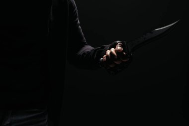 Cropped view of african american robber holding knife isolated on black  clipart
