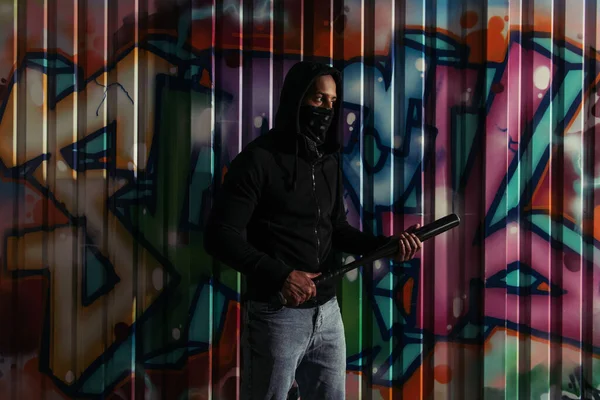African American Vandal Hoodie Holding Baseball Bat Graffiti Outdoors Night — Stok fotoğraf