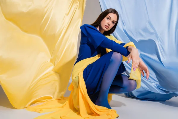 Young Ukrainian Woman Stylish Color Block Clothing Sitting Blue Yellow — Photo