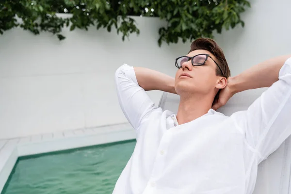 Man Eyeglasses Relaxing Closed Eyes Hands Head Pool — 스톡 사진