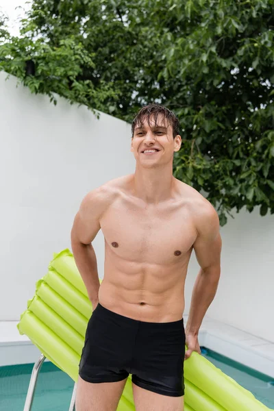 Cheerful Man Swimming Trunks Standing Swimming Mattress Outdoors — Foto de Stock