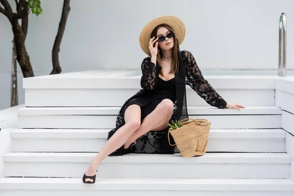 Fashionable Woman Swimsuit Guipure Robe Holding Sunglasses While Sitting Stairs — 스톡 사진
