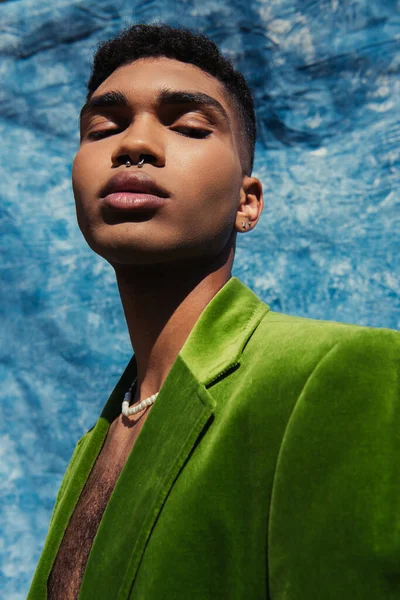 African American Man Piercing Posing Green Blazer Beads Blue Drape —  Fotos de Stock