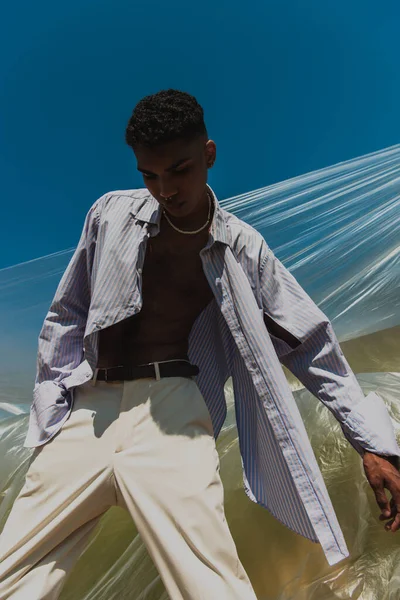 Low Angle View African American Man Striped Shirt Posing Polyethylene — Foto de Stock