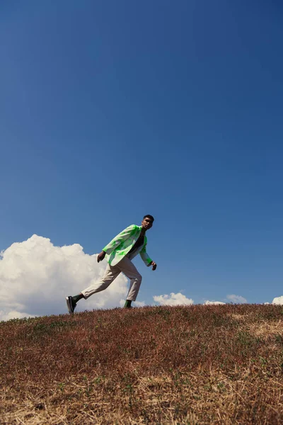 Fashionable African American Man Running Field Blue Sky White Clouds — Stockfoto