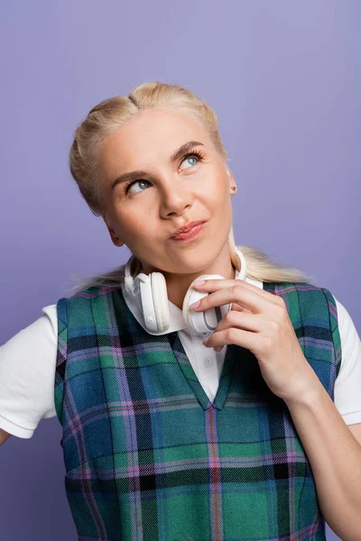Dreamy Blonde Student Looking Holding Headphones Isolated Purple — Stockfoto