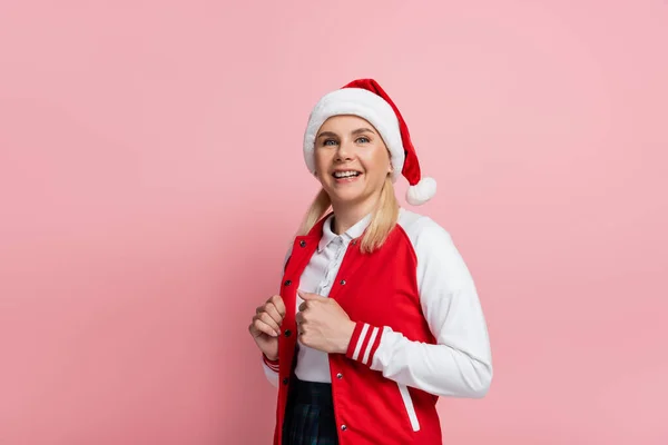 Smiling Woman Santa Hat Looking Camera Isolated Pink — Zdjęcie stockowe