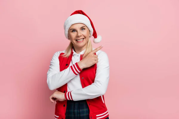 Positive Woman Santa Hat Pointing Finger Looking Camera Isolated Pink — Foto de Stock