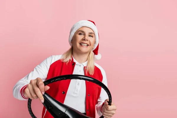 Smiling Woman Santa Hat Holding Steering Wheel Isolated Pink — Zdjęcie stockowe