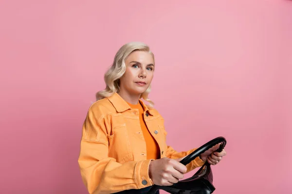 Blonde Woman Jacket Holding Steering Wheel Isolated Pink — Zdjęcie stockowe