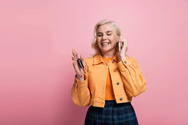 Happy Blonde Woman Holding Car Key Talking Mobile Phone Isolated — Fotografia de Stock