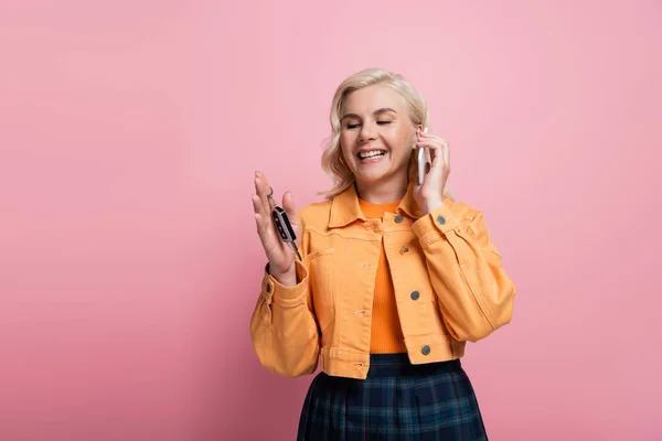 Happy Blonde Woman Holding Car Key Talking Mobile Phone Isolated — Stockfoto