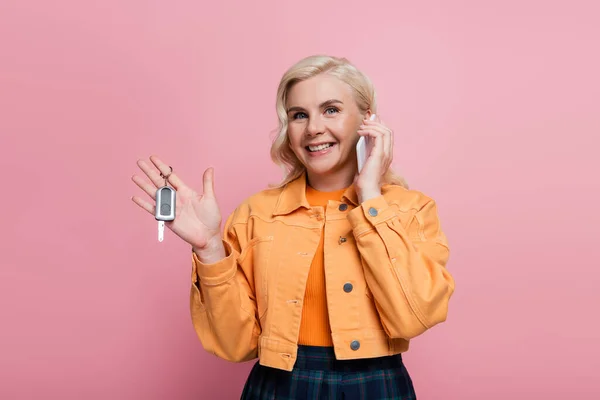 Positive Woman Jacket Talking Smartphone Holding Car Key Isolated Pink — 스톡 사진