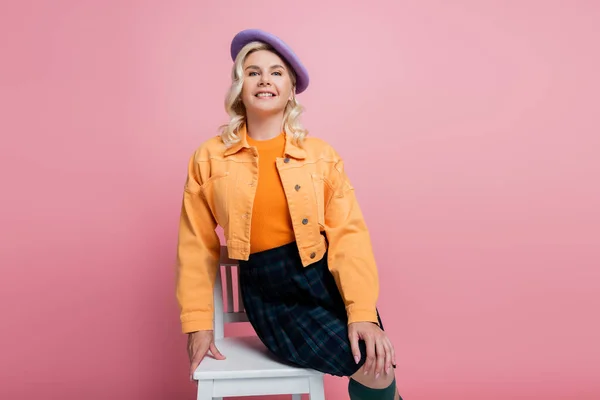 Happy Woman Jacket Beret Posing Chair Isolated Pink — Φωτογραφία Αρχείου