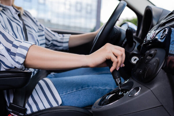 Cropped view of woman driving car during course 