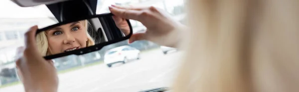 Blurred Woman Adjusting Mirror Car Banner — Zdjęcie stockowe