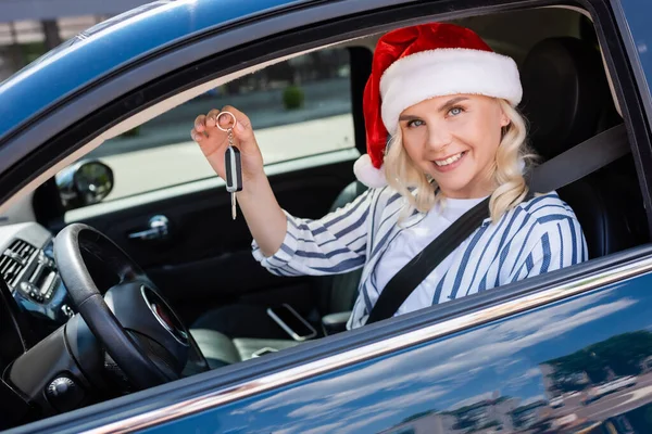 Positive Owner Santa Hat Holding Key While Sitting Auto — 스톡 사진