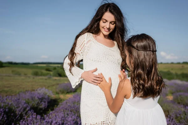 Brunette Girl Embracing Belly Pregnant Mother Wearing White Openwork Dress — Foto de Stock