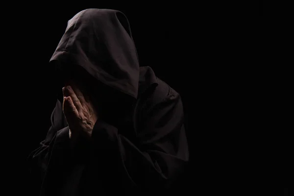 Mysteriöser Priester Kapuzenmantel Betet Isoliert Auf Schwarz — Stockfoto