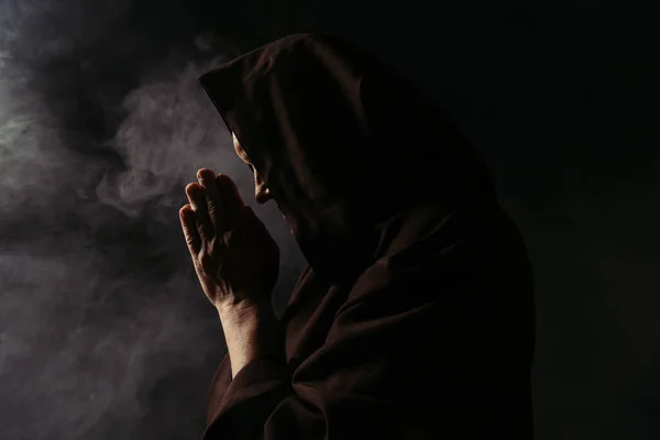 Side View Priest Face Obscured Hood Praying Black Smoke — Stock Photo, Image