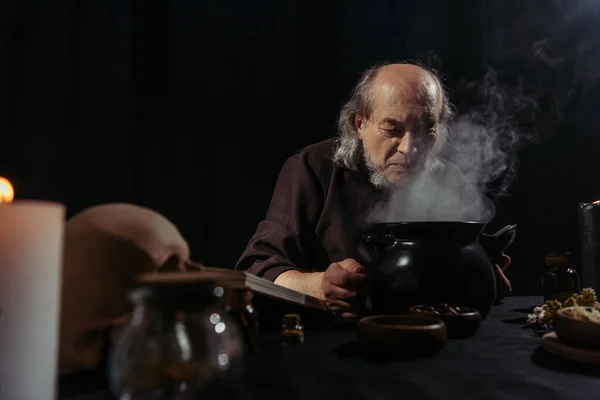 Senior Alchemist Boiling Steaming Pot Preparing Potion Night Isolated Black — Stock Photo, Image