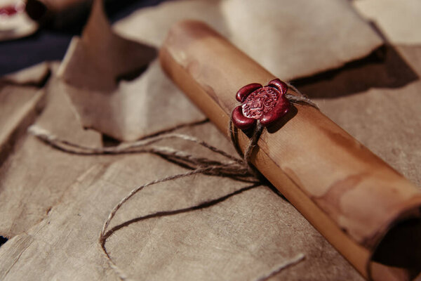 close up view of medieval manuscript with rope and wax seal on parchment surface