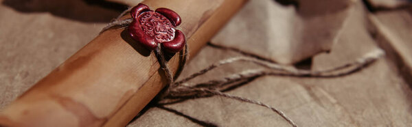 close up view of manuscript stamped with wax seal on craft paper surface, banner