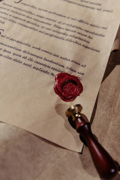 top view of wax seal on ancient manuscript on parchment surface
