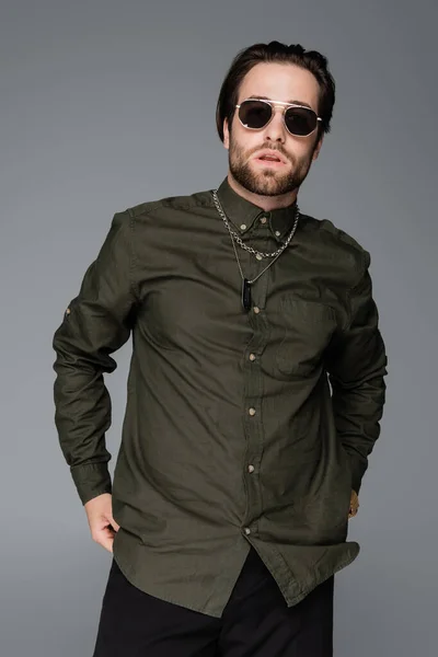 Bearded Man Stylish Green Shirt Sunglasses Looking Camera Isolated Grey — Stockfoto