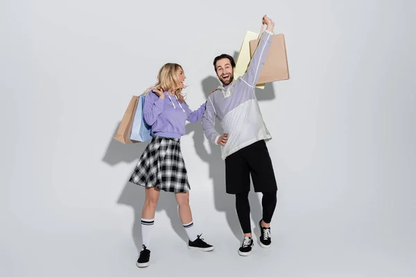 Full Length Excited Man Cheerful Woman Tartan Skirt Holding Shopping — Foto de Stock