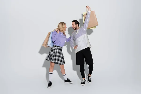 Full Length Excited Man Happy Woman Tartan Skirt Holding Shopping — Fotografia de Stock